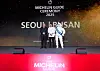 Chef Kang Min-goo, middle, poses with Managing Director of Michelin Korea Jerome Vincon after his restaurant Mingles in Seoul was awarded three stars during the Michelin Guide Seoul & Busan 2025 ceremony at The Westin Josun Seoul in Jung District, central Seoul, on Thursday. [MICHELIN GUIDE]