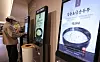 A person buys food items at a food court in a shopping mall in Seoul on March 27. [NEWS1]