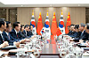 Top: President Yoon Suk Yeol, left, and Chinese Premier Li Qiang, right, hold a bilateral meeting at the Yongsan presidential office in central Seoul on Sunday, ahead of a trilateral summit with Japan Monday. [PRESIDENTIAL OFFICE]