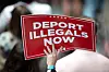A supporter of Donald Trump holds up a sign reading ″deport illegals now″ during a campaign rally at the Bojangles Coliseum in Charlotte, North Carolina, on July 24, 2024. [YONHAP/AFP]