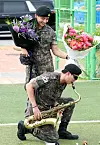 BTS members V, top, and RM, greet fans after finishing their military duties on June 11 in Yeoncheon, Gyeonggi. [NEWS1]