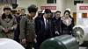 North Korean leader Kim Jong-un, center, tours a weapons facility with his daughter, Kim Ju-ae, right of center, in this photo released by the Korean Central News Agency on Dec. 24. [KOREAN CENTRAL NEWS AGENCY]