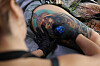 A tattooist works at a parlor in Seoul on Aug. 27. [YONHAP]