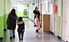 Parents and their kids take a look around the school in Incheon on Jan. 7 before the new semester starts in March. [YONHAP]