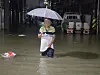 A citizen walks through a flooded road in Unam-dong, Buk District, in Gwangju, on Aug. 3 at night as heavy rain hits the southern regions of Korea. [GWANGJU BUKGU]