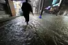 A citizen walks through a flooded road in Unam-dong, Buk District, in Gwangju, on Aug. 3 at night as heavy rain hits the southern regions of Korea. [YONHAP]