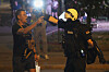 A Serbian riot police officer directs a man filming after clearing people blocking a street during an anti-government protest in Belgrade, Serbia, on Aug. 16. [AP/YONHAP]