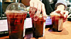 A cafe employee sorts plastic cups of cofee at a cafe in Seoul on Dec. 18, 2025. [NEWS1]