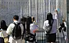 Visitors color a painting, inspired by byeongpung (folding screen) featuring Hwaseong at this year's Suwon Hwaseong Cultural Festival. [NEWS1]