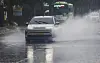 Vehicles cautiously drive through spray on a road beside the Gwangjucheon in Wolsan-dong, Nam District, Gwangju, as a heavy rain advisory is issued for parts of Gwangju and South Jeolla on July 13. [NEWS1]