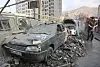 People gather near damaged vehicles in the aftermath of Israeli strikes, in Tehran, Iran, on June 13 in this photo provided by West Asia News Agency. [REUTERS/YONHAP]