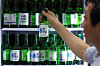 A worker organizes bottles of soju at a restaurant in Jongno District, central Seoul, on July 8. [NEWS1]