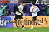 Son Heung-min, left, runs past Lee Kang-in while warming up ahead of the Asian Cup semifinal against Jordan in Qatar on Feb. 6. [NEWS1]