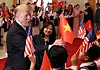 U.S. President Donald Trump is handed a Vietnamese flag as he is greeted by students at the Office of Government Hall in Hanoi, Vietnam, on Feb. 27, 2019. [REUTERS/YONHAP]