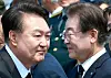 Impeached and former President Yoon Suk Yeol, left, is seen together with liberal Democratic Party leader Lee Jae-myung in a photo taken last year. [YONHAP]