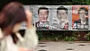 A pedestrian walks by presidential candidates' campaign posters attached to a wall in Mapo District, western Seoul, on May 23. [YONHAP]
