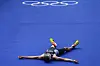 France's Leo Bergere lays on the floor at the end of the men's individual triathlon competition in Paris on Wednesday. [AP/YONHAP]