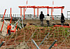 At Muan International Airport in South Jeolla on April 22, officials from the Aviation & Railway Accident Investigation Board examine the localizer facility as part of their investigation into the Jeju Air passenger plane incident.[YONHAP]