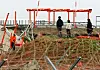 At Muan International Airport in South Jeolla on April 22, officials from the Aviation & Railway Accident Investigation Board examine the localizer facility as part of their investigation into the Jeju Air passenger plane incident.[YONHAP]