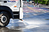 A sprinkler truck sprays water on a road in front of the Pohang International Exhibition & Convention Center (POEX) in Pohang, North Gyeongsang on July 3. [NEWS1]