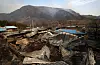 PIctured are destroyed residences in Sicheon-myeon, Sancheong County, South Gyeongsang as the wildfire rages on behind the neighborhood on March 23. [NEWS1]