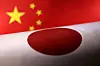 Printed Chinese and Japanese flags are seen in this illustration created on July 21, 2022. [REUTERS/YONHAP]