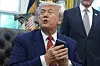 President Donald Trump holds his phone as he speaks to reporters after signing executive orders regarding nuclear energy in the Oval Office of the White House on May 23, 2025, in Washington. [AP/YONHAP]