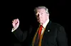 President Donald Trump is illuminated by a camera flash as he gestures while walking across the South Lawn of the White House in Washington after returning from a trip to Florida on Nov. 2, 2025. [AP/YONHAP]