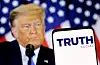 The Truth social network logo is seen on a smartphone in front of a display of U.S. President Donald Trump in this picture illustration taken on Feb. 21, 2022. [REUTERS/YONHAP]