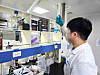 Ying Wei Wang inspects samples at a lab. [HUONS]
