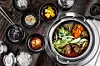 Braised beef and various side dishes are pictured with a pair of metal chopsticks [GETTY IMAGE BANK]