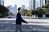 Author Song Hee-koo, who wrote ″The Story of Manager Kim,″ the original source novel behind the hit JTBC drama series ″The Dream Life of Mr. Kim,″ walks across a street in Seocho District, southern Seoul before an interview with the JoongAng Ilbo on Nov. 5. [KWEN HYEK-JAE]