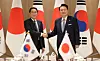 Korean President Yoon Suk Yeol, right, and Japanese Prime Minister Fumio Kishida shake hands during their summit in Seoul on Friday. [JOINT PRESS CORPS]