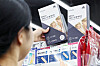 A worker at a convenience store in Seoul places at-home Covid test kits on a stall on Wednesday. [NEWS1]