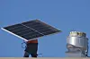 A worker carries a solar panel on the roof of the Alta Sea building, an urban, ocean-based research and blue technology innovation campus, at Berth 58 in the Port of Los Angeles on Sept. 4. [AP/YONHAP]