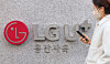 A pedestrian passes by the LG U+ headquarters in Yongsan District, central Seoul, on Dec. 7, 2025. [YONHAP]