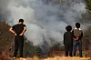 Residents in Sicheon-myeon, Sancheong County, South Gyeongsang look at a house blazed by the wildfire that has been sweeping the county on March 23. [YONHAP]