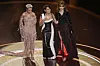 From left are Doja Cat, Raye, and Lisa on stage during the Oscars on March 2, at the Dolby Theatre in Los Angeles. [AP/YONHAP]