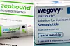 A combination image shows an injection pen of Zepbound, Eli Lilly's weight loss drug, and boxes of Wegovy, made by Novo Nordisk. [REUTERS/YONHAP]