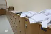 White medical gowns are placed on a cabinet inside a medical school's building in Seoul on Thursday. [YONHAP]