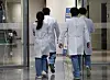 Medical professionals walk inside Korea University Anam Hospital in Seongbuk District, central Seoul, on Thursday, a day before the hospital's medical professors go on an indefinite strike. [NEWS1]