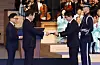 President Lee Jae Myung, left, presents the Order of Merit for National Foundation to a descendent of an independence activist during a ceremony marking the 80th Liberation Day at the Sejong Center for Performing Arts in Jongno District, central Seoul, on Aug. 15. [JOINT PRESS CORPS]