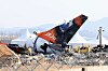 Firefighters remove tarpaulin sheets covering the debris of a Jeju Air passenger plane at Muan International Airport, South Jeolla, on Jan. 13, following its crash on Dec. 29, 2024. [YONHAP]