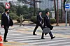 Lee Jae-myung, a presidential primary candidate for the liberal Democratic Party, walks with a security detail at Yeouido, western Seoul, on March 17. [YONHAP]