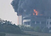 Flames and black smoke from a fire that broke out at a logistics center in Icheon, Gyeonggi, are pictured on May 13. [YONHAP]