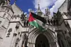 A demonstrator waves a flag outside the High Court in London where a full hearing on an application for a judicial review by Palestine Action against its impending proscription is being heard on July 21. [AP/YONHAP]