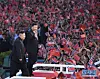 Chinese President Xi Jinping, right, waves to people in Pyongyang during his visit to the North Korean capital, accompanied by North Korean leader Kim Jong-un, left, at the May Day Stadium on June 20, 2019. [SCREEN CAPTURE]
