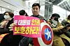 Ahn, holds up a placard saying ″Protect President Yoon Suk Yeol's human rights″ while wearing a costume of Captain America at the National Human Rights Commission of Korea's building on Feb. 10. [NEWS1]