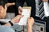 An election official hands a ballot to a voter on the first day of early voting for the 21st presidential election in Gwangju on May 29. [NEWS1]