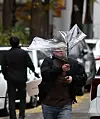 A man struggles to keep his umbrella open against the wind in Mapo District, western Seoul, on Tuesday, when rain fell across much of the country ahead of an expected cold spell. [YONHAP]